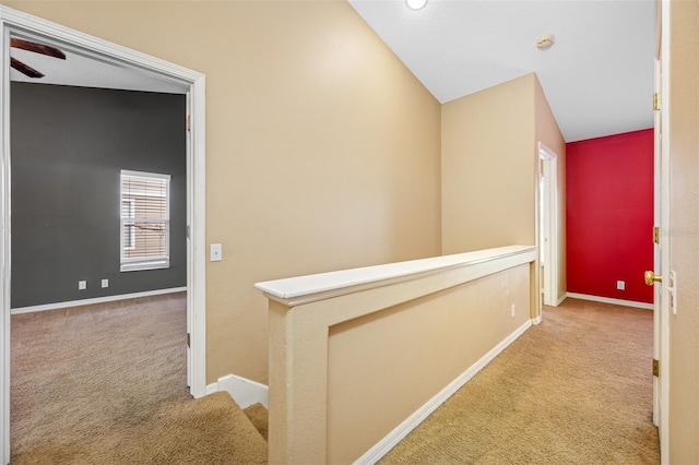 hall with light carpet and lofted ceiling