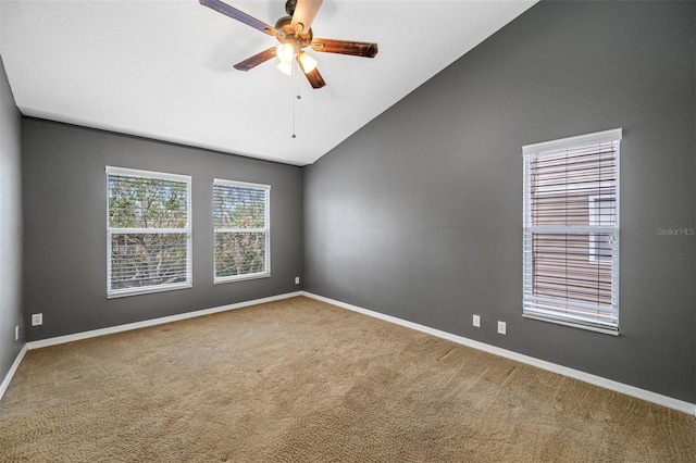 unfurnished room featuring carpet, vaulted ceiling, and ceiling fan