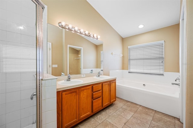 bathroom featuring vaulted ceiling, tile patterned flooring, shower with separate bathtub, and vanity