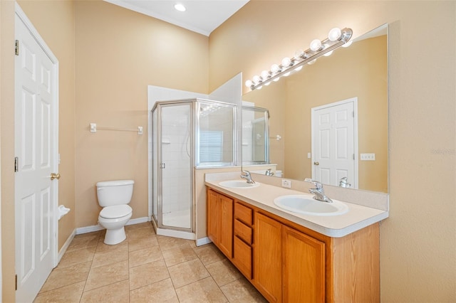 bathroom featuring toilet, tile patterned flooring, a shower with door, and vanity