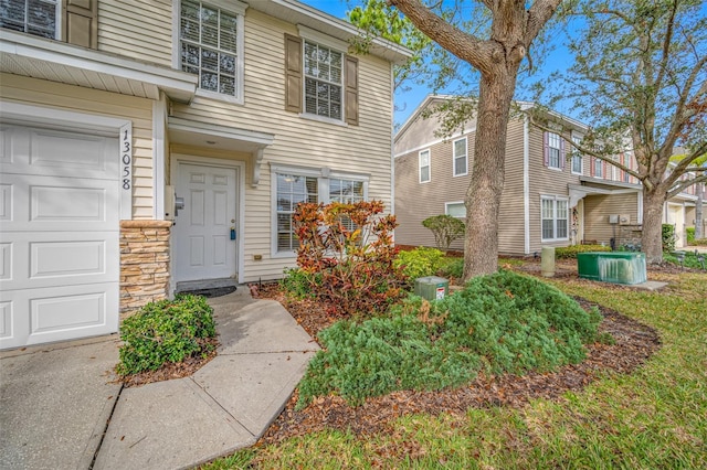 doorway to property featuring a garage and central AC