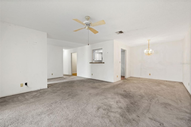 unfurnished living room with ceiling fan with notable chandelier and light colored carpet