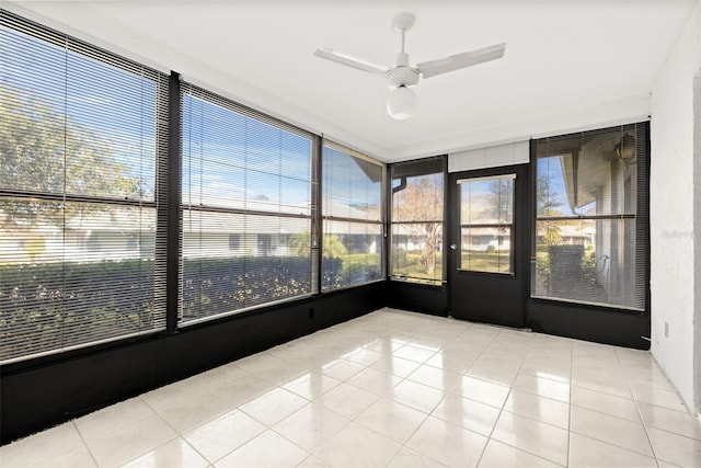 unfurnished sunroom with ceiling fan