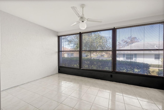 unfurnished room featuring ceiling fan and light tile patterned floors