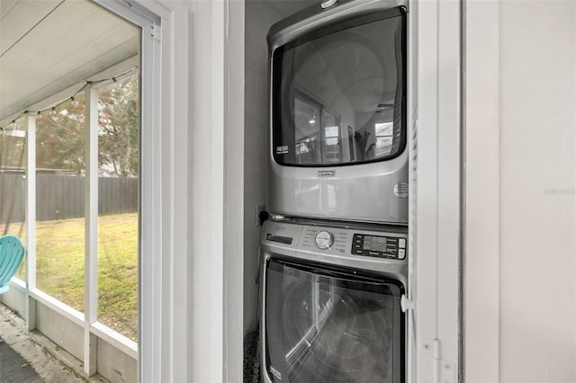 laundry room with stacked washer / drying machine