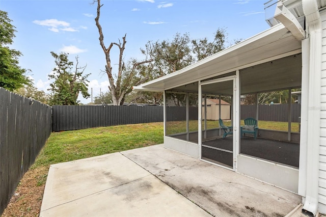 view of patio with a sunroom and a storage shed