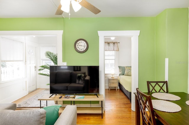 living room featuring ceiling fan and hardwood / wood-style flooring