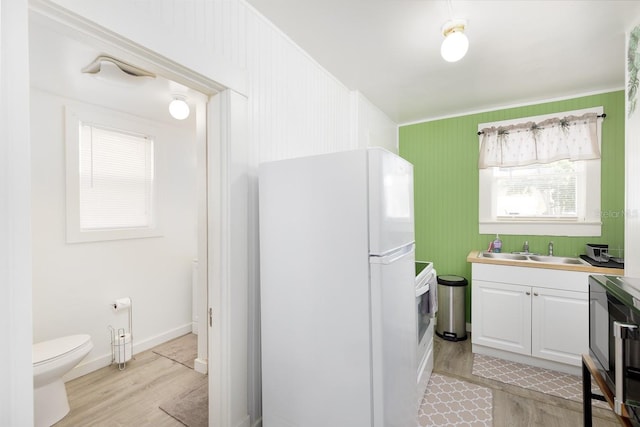 bathroom with toilet, wood-type flooring, and vanity