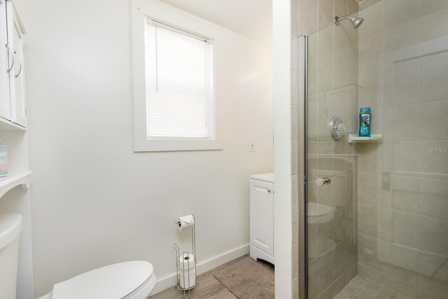 bathroom with toilet, tile patterned flooring, and a shower with shower door