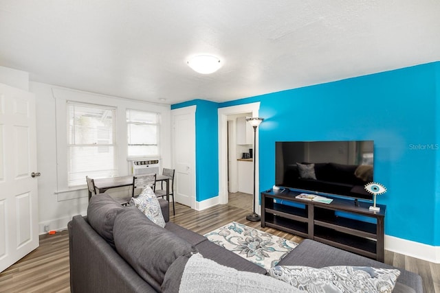 living room with cooling unit, a textured ceiling, and dark wood-type flooring