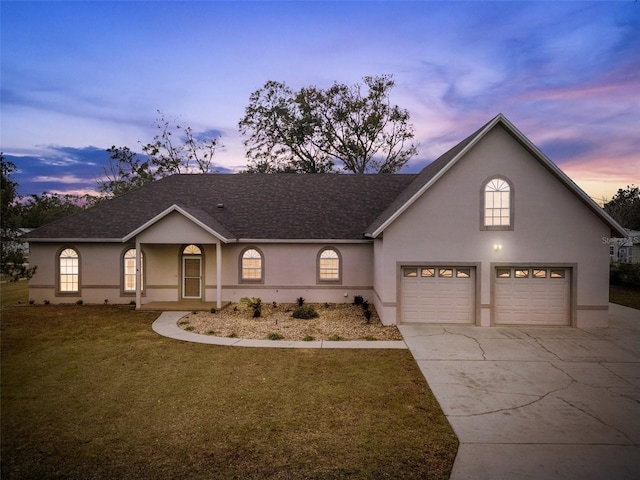 view of front facade featuring a garage and a lawn