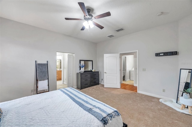 carpeted bedroom with ceiling fan, washer / clothes dryer, and ensuite bathroom