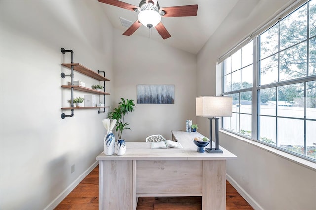 office space with ceiling fan, vaulted ceiling, and dark wood-type flooring