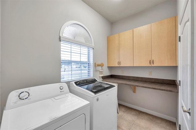 washroom with independent washer and dryer and cabinets