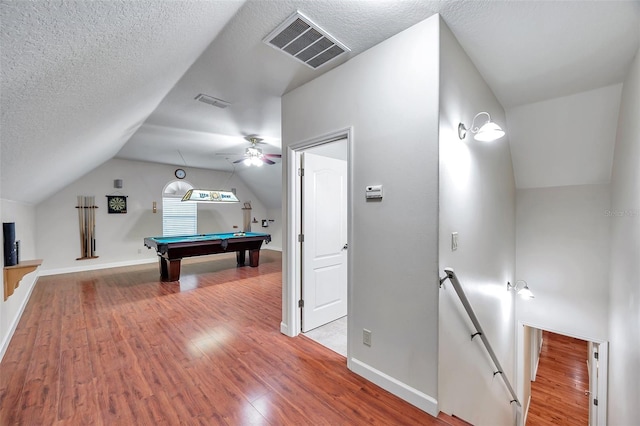 playroom with hardwood / wood-style floors, a textured ceiling, pool table, vaulted ceiling, and ceiling fan