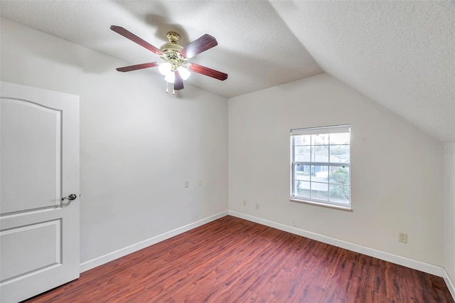 bonus room featuring ceiling fan, a textured ceiling, dark hardwood / wood-style flooring, and vaulted ceiling