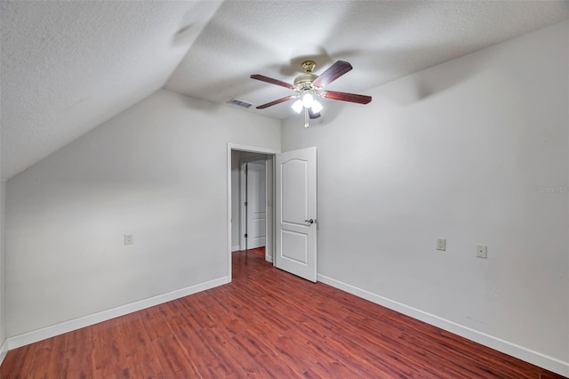 bonus room featuring ceiling fan, vaulted ceiling, dark hardwood / wood-style flooring, and a textured ceiling