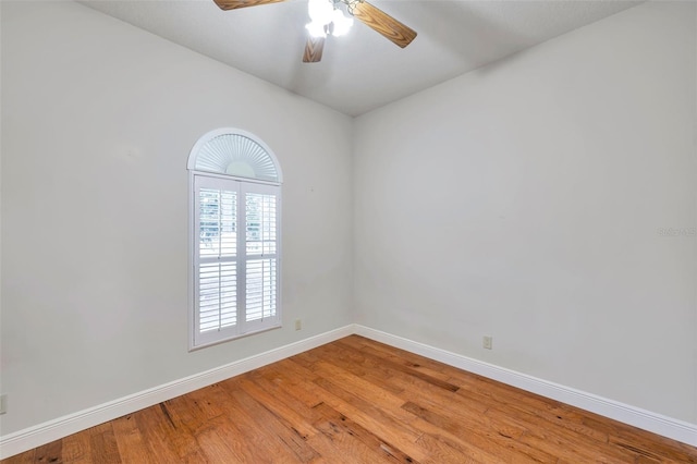 spare room with hardwood / wood-style flooring and ceiling fan