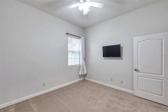 unfurnished room featuring ceiling fan and light colored carpet