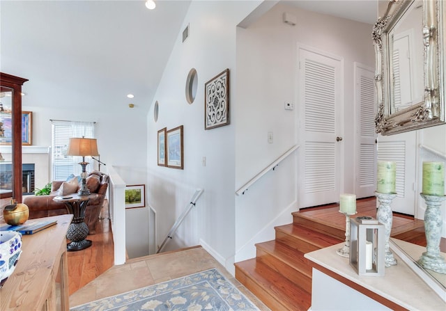 stairway with a tile fireplace