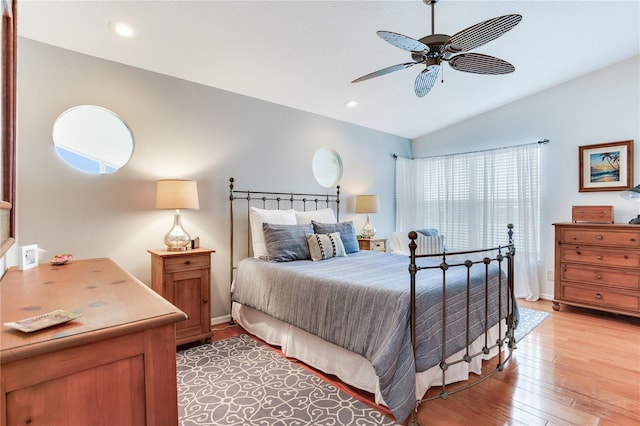 bedroom with vaulted ceiling, ceiling fan, and hardwood / wood-style flooring