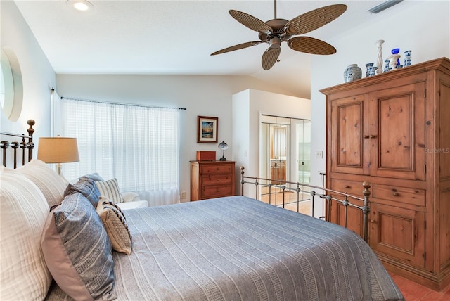 bedroom featuring ceiling fan, lofted ceiling, hardwood / wood-style flooring, and a closet