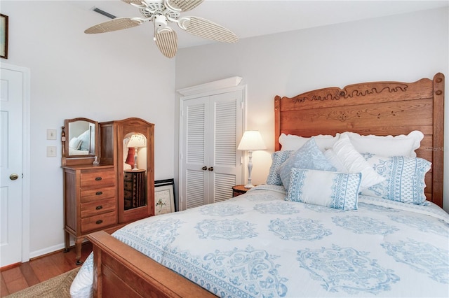 bedroom featuring ceiling fan, a closet, and hardwood / wood-style flooring