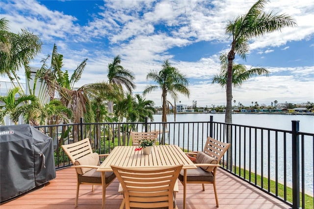 wooden terrace with grilling area and a water view