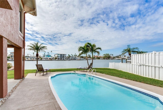 view of pool with a patio area and a water view