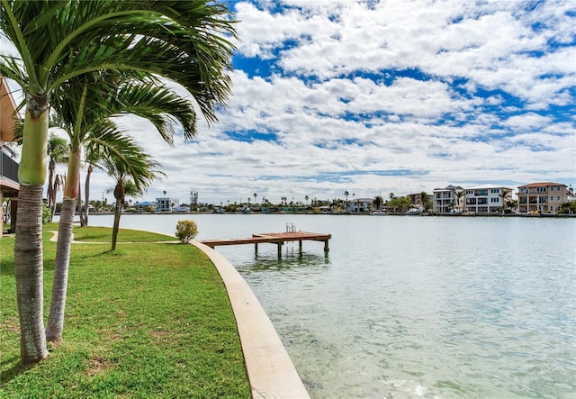 view of dock featuring a water view and a lawn