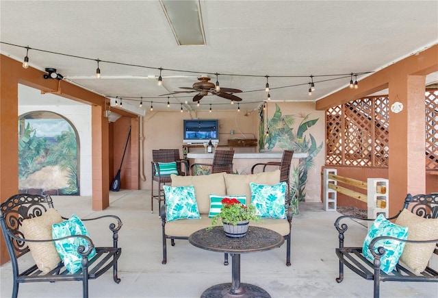 view of patio / terrace with ceiling fan and an outdoor living space