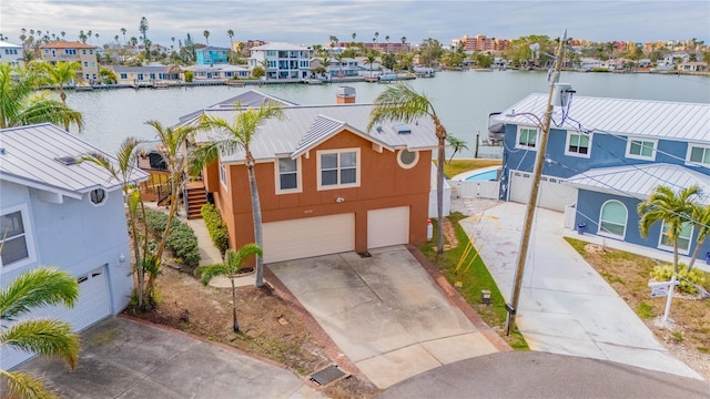 view of front of house featuring a garage and a water view