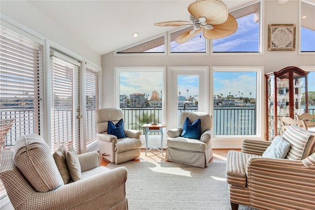 sunroom / solarium featuring vaulted ceiling, a water view, and ceiling fan