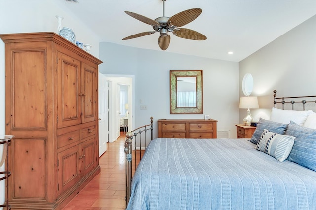 bedroom with ceiling fan, light wood-type flooring, and lofted ceiling