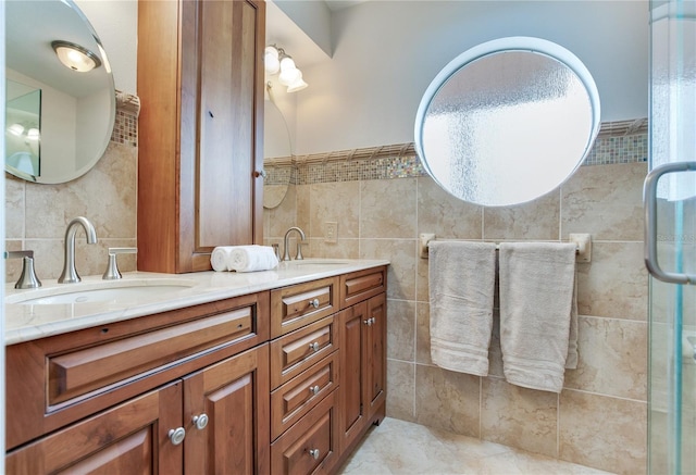 bathroom featuring tile walls, vanity, and a shower with door