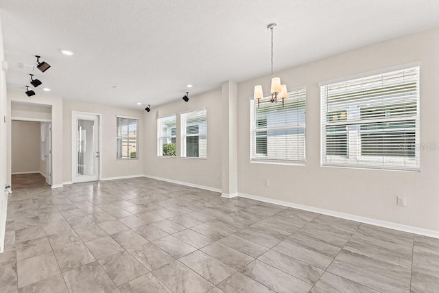 empty room featuring a notable chandelier