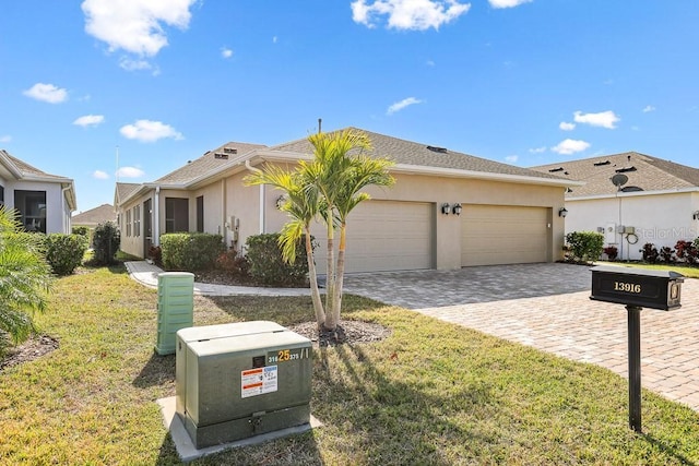 ranch-style home featuring a garage and a front yard