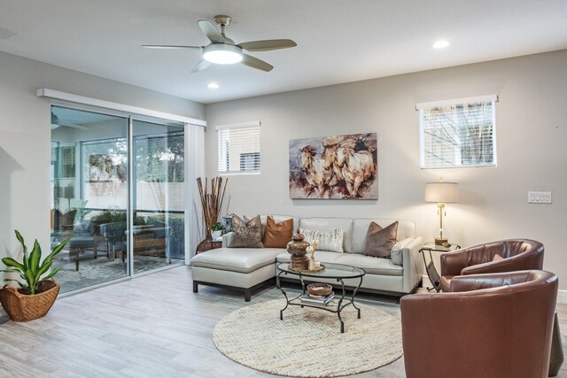 living room with light wood-type flooring and ceiling fan