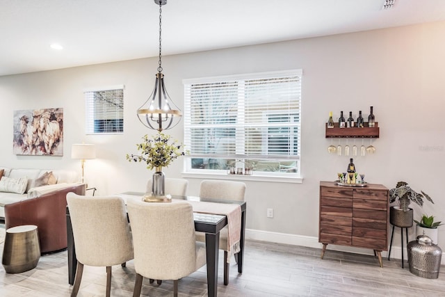 dining room with a notable chandelier and light hardwood / wood-style flooring