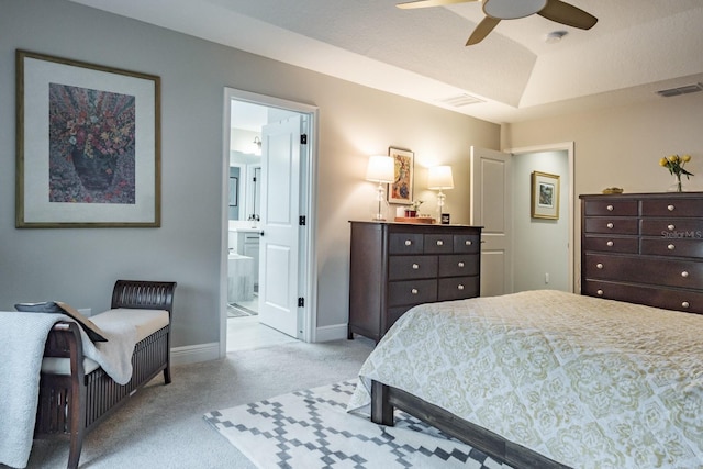 bedroom featuring ensuite bathroom, ceiling fan, and light carpet