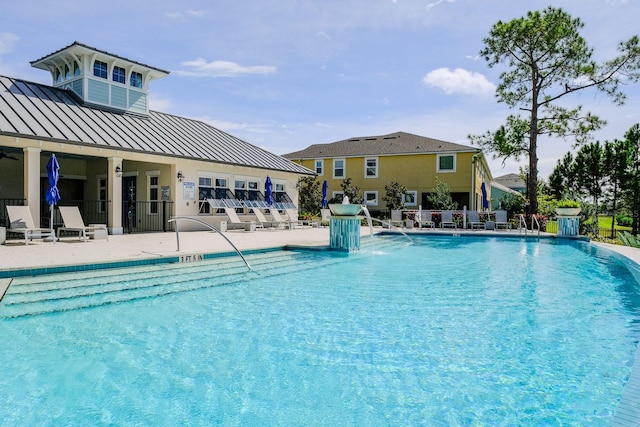 view of swimming pool featuring a patio and pool water feature