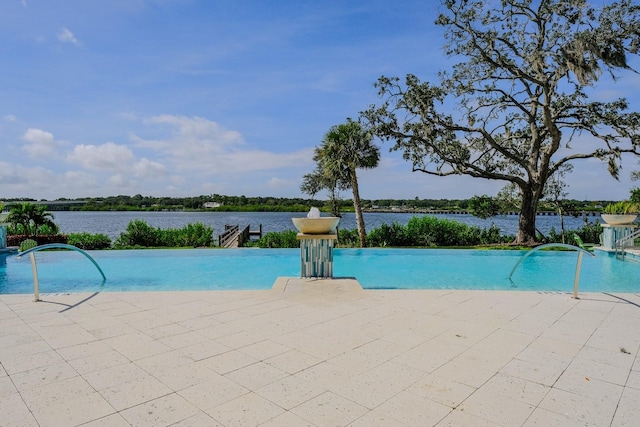 view of swimming pool with a water view