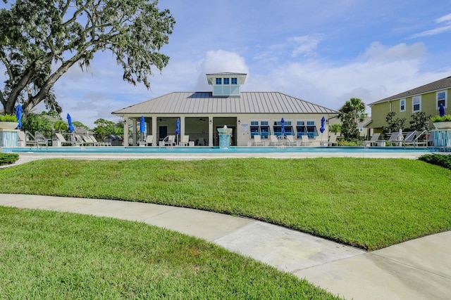 view of pool with pool water feature, a patio area, and a yard