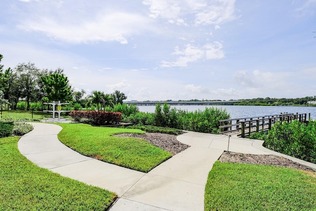 view of home's community featuring a water view and a lawn