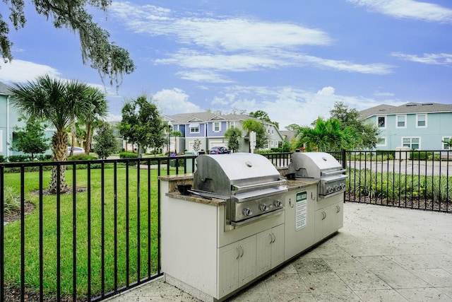 view of patio featuring area for grilling and a grill