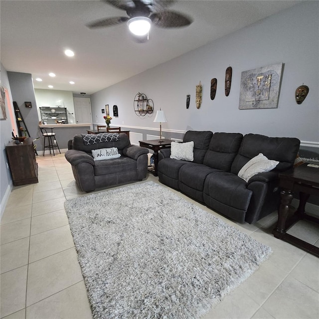 living room featuring ceiling fan and light tile patterned floors