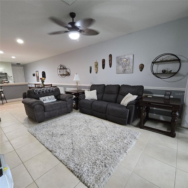 tiled living room featuring ceiling fan