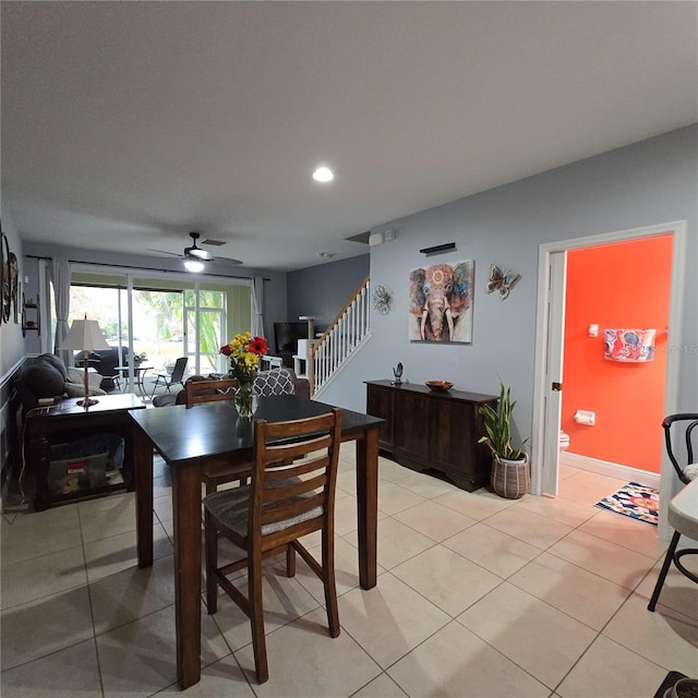 dining space featuring ceiling fan and light tile patterned floors