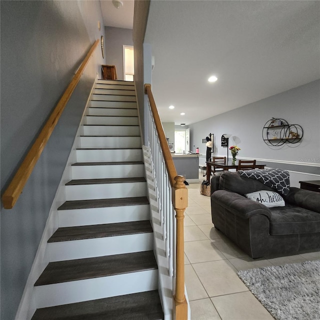 stairway featuring tile patterned flooring