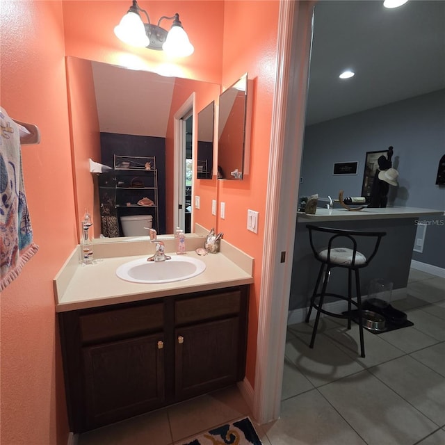 bathroom with vanity, tile patterned floors, and toilet